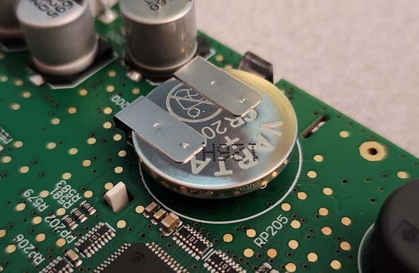 Close up of a CR2032 (by VARTA) tack welded onto a PCB