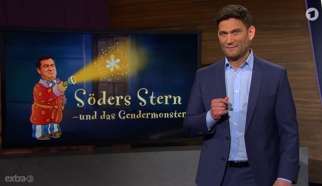 Screenshot aus der Sendung extra3 mit Christian Ehring - zu sehen: eine Karikatur von Markus Söder im Schlafrock mit Taschenlampe auf einen Stern leuchtend.
Dazu als Text: Söders Stern - und das Gendermonster 