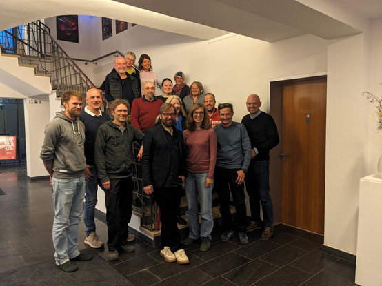 16 Menschen, stehen vor und auf einer Treppe, alle kandidierende auf der MfG/PIRATEN Liste.
Junge und ältere, Frauen und Männer und alle lächeln freudig in Richtung der Fotografen.

Vorne in der Mitte mit Brille und Anzug, Bürgermeisterkandidat Stefan Berchtold.
Vorne in der Mitte mit ebenfalls mit Brille, Valeria Mayer.
Vorne der zweite von Rechts, Axel Höpner.
Vorne der dritte von Links: Tobias McFadden(aka Kalle).